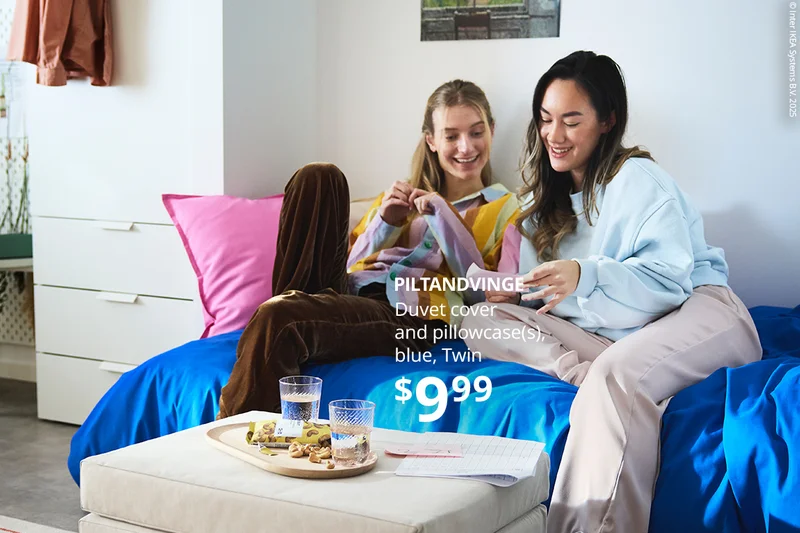 Two people sitting on a bed