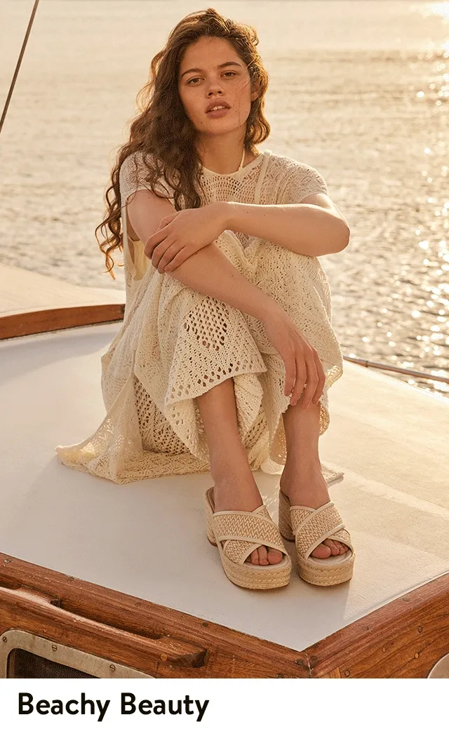 A model wearing raffia sandals.
