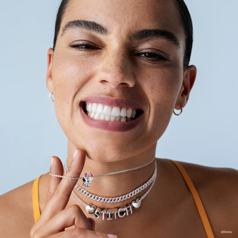 Model wears Disney's Stitch jewelry by Disney x Pandora