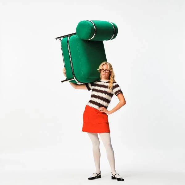 girl with green chair on her shoulder
