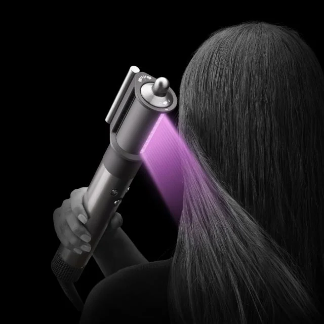 Model drying hair with the Dyson Airwrap multi-styler