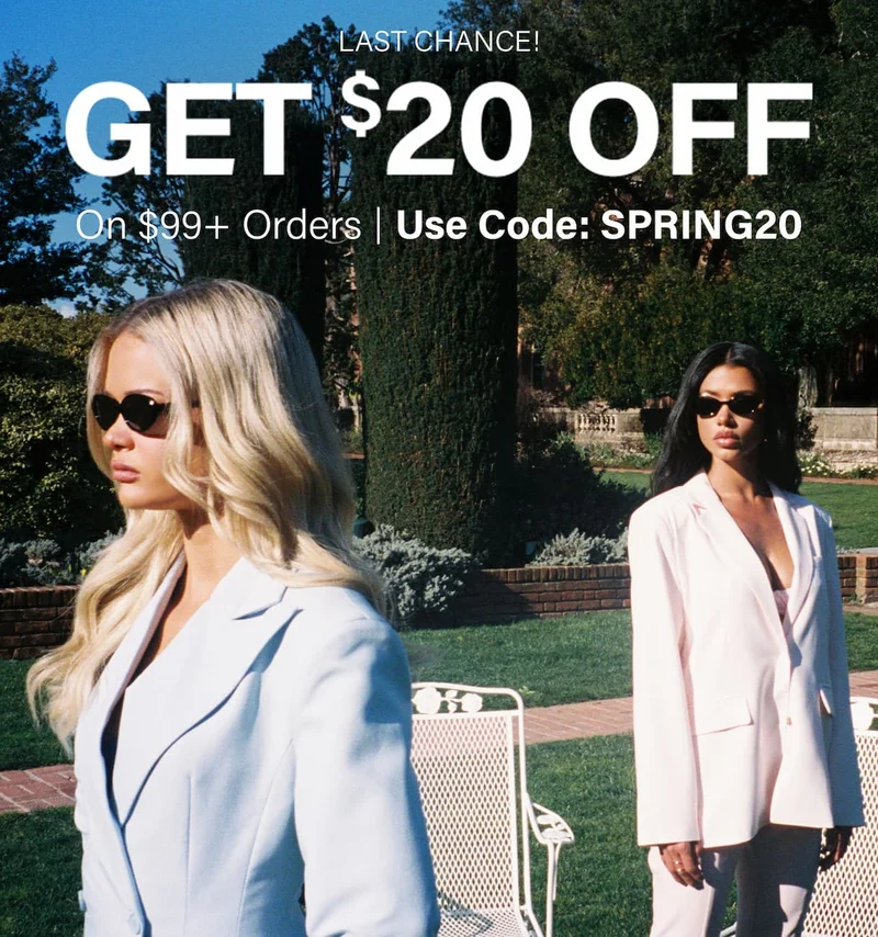 Two women in light blue and pink spring blazers, sunglasses, in a sunny garden. Get $20 off women's apparel with code discount code.