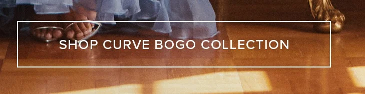 Feet in silver sandals, a flowing light dress on a warm wood floor, promoting the plus-size Curve BOGO Collection sale.