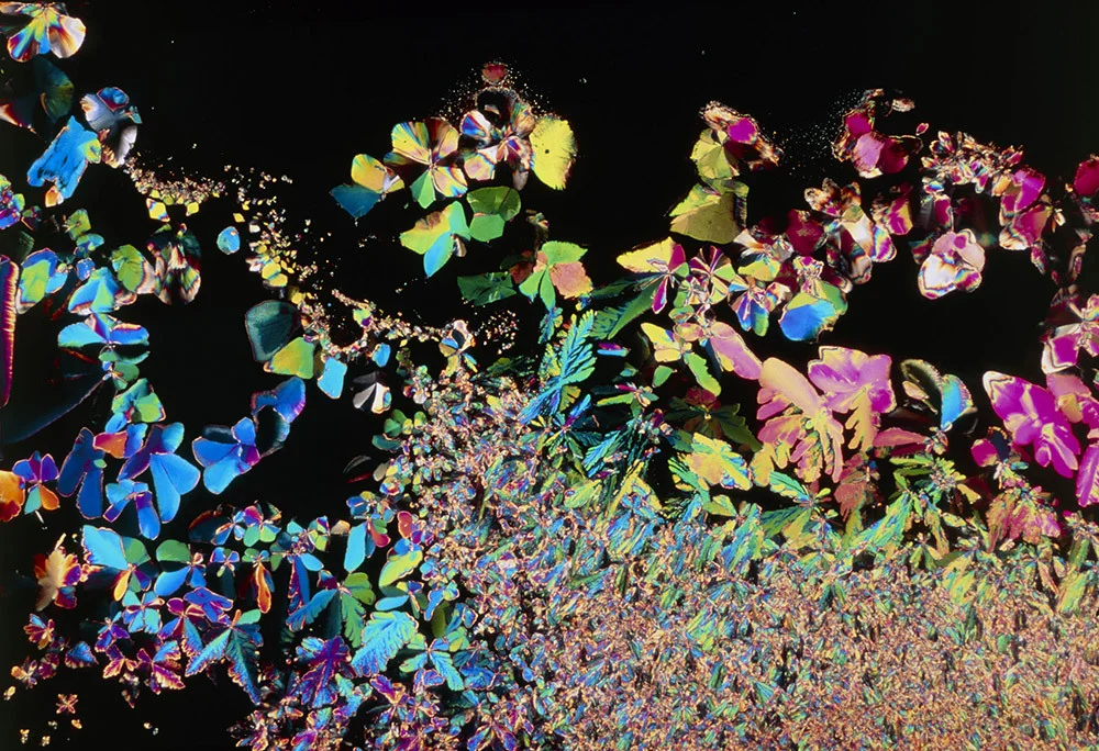 A multi-colored, kaleidoscope of crystalized shapes ranging from small to micro sizes