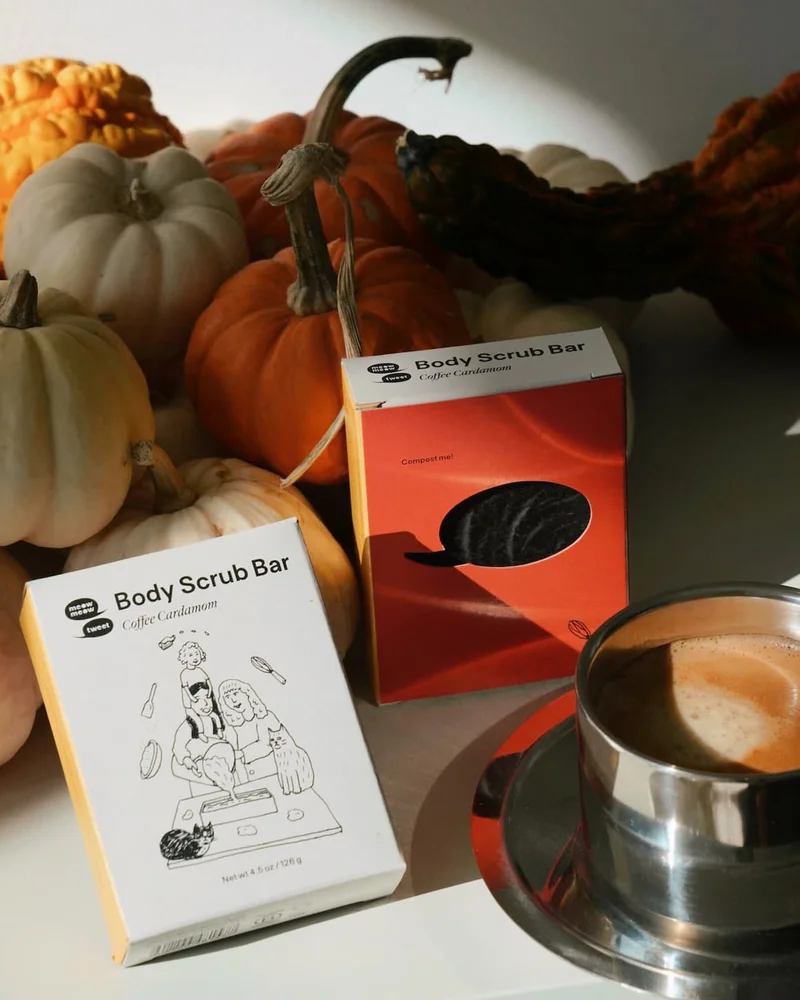 a bra of coffee soap in a white box is arranged with little gourds and pumpkins and a beautiful espresso in a metal cup