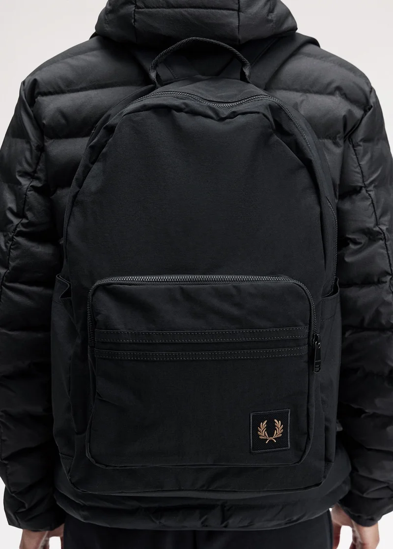 Close up of a Fred Perry Nylon Badge Backpack in Black