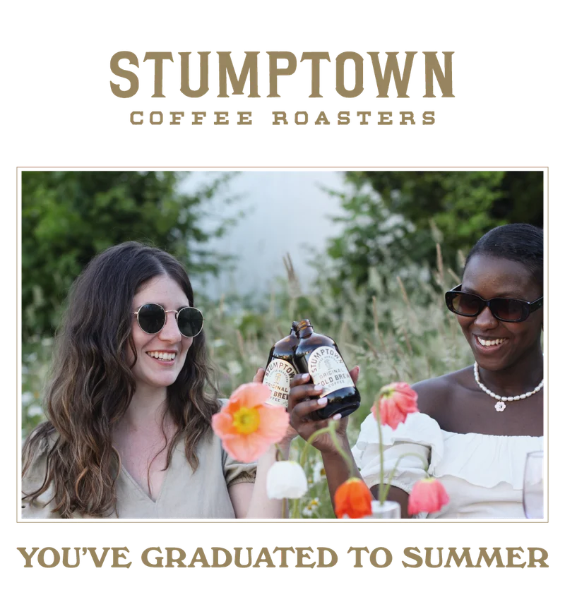 Two people smiling and holding bottles of Stumptown Original Cold Brew Coffee in sunny outdoor garden, with the headline “You’ve Graduated to Summer.”