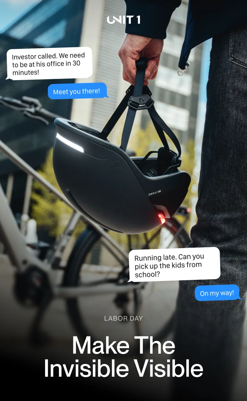 Cyclist wearing UNIT 1 smart helmet with lights. Text overlay: Dad, can you pick me up from piano class? Headline: The Jobs You Do That No One Sees – Labor Day.