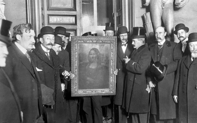 People gather around the Mona Lisa painting in Paris, three years after it was stolen from the Louvre by Vincenzo Peruggia in 1911.