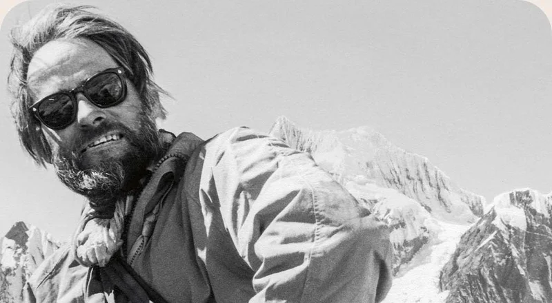 An old photo of a person in the mountains.