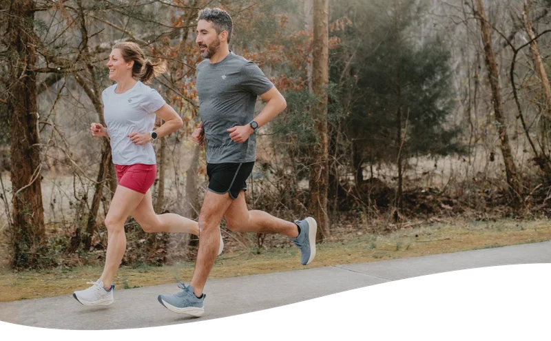 woman and man running outside