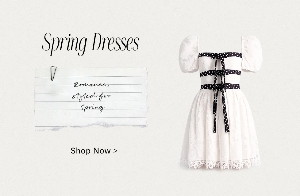 Romantic white puff sleeve spring dress with black polka dot ribbons and lace hem, promoting a new collection of Spring Dresses. Shop Now!