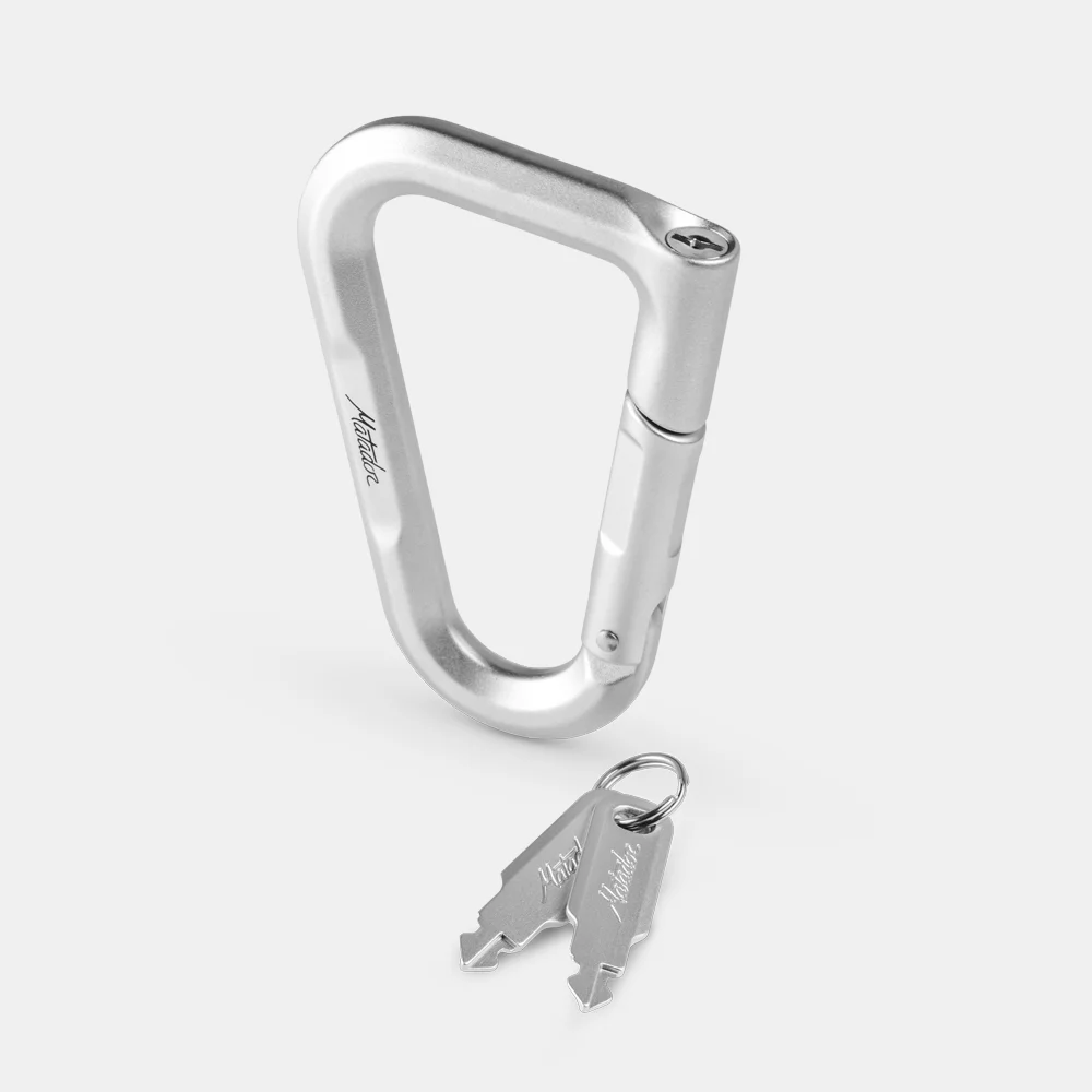 Silver carabiner lock and keys on light tray background