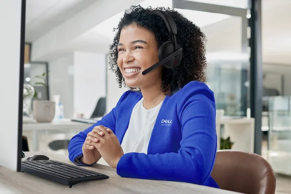 A happy Dell Customer Service team member on a support call.