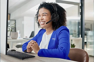 A happy Dell Customer Service team member on a support call.