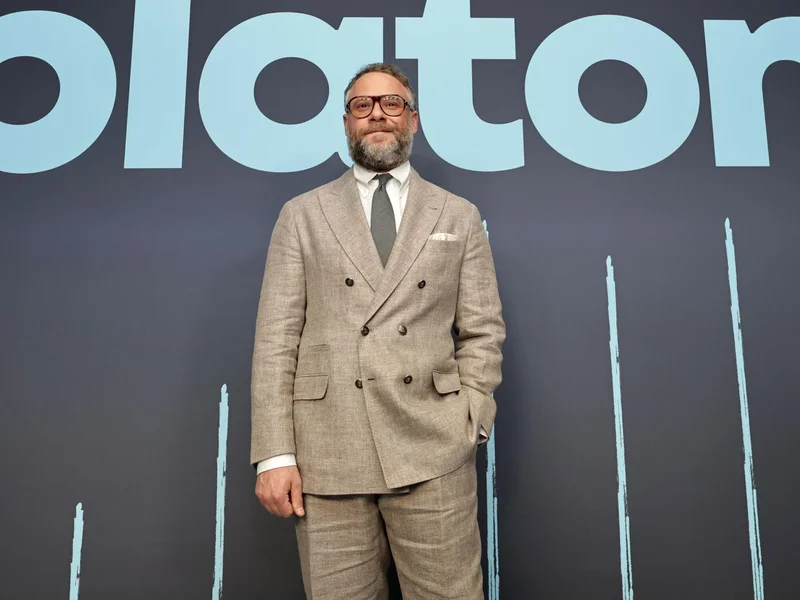 Image may contain: Seth Rogen, Clothing, Coat, Jacket, Blazer, Formal Wear, Suit, Adult, Person, People, Accessories, and Tie