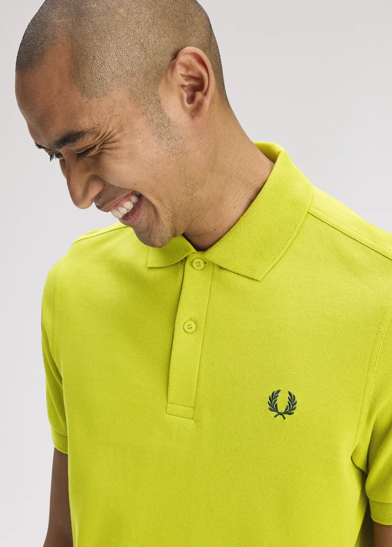 Male model wearing a Fred Perry Shirt in Tennis Ball Yellow