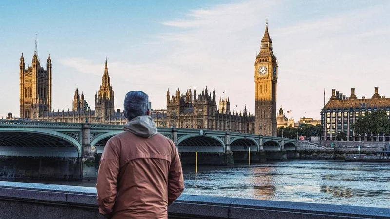 Image description: A man looks at Big Ben and Westminster Bridge in London at sunrise.