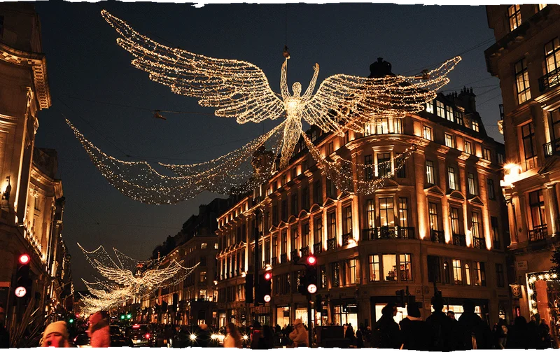 Image Description: Travelers admiring the massive Regent Street festive light-ups, featuring the floating light sculpture of an angel