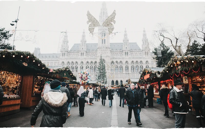 Image Description: A crowd of travelers shopping at the Vienna Christmas Market