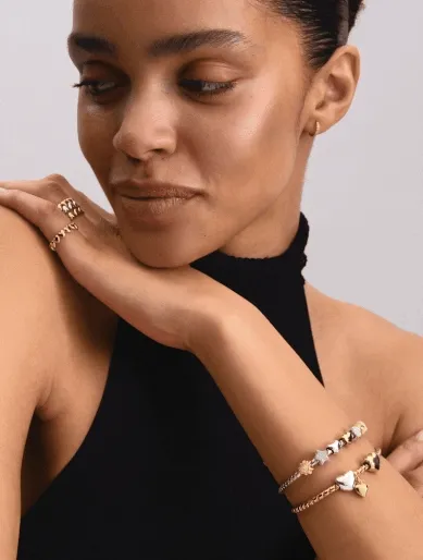 Model wearing silver and gold charms