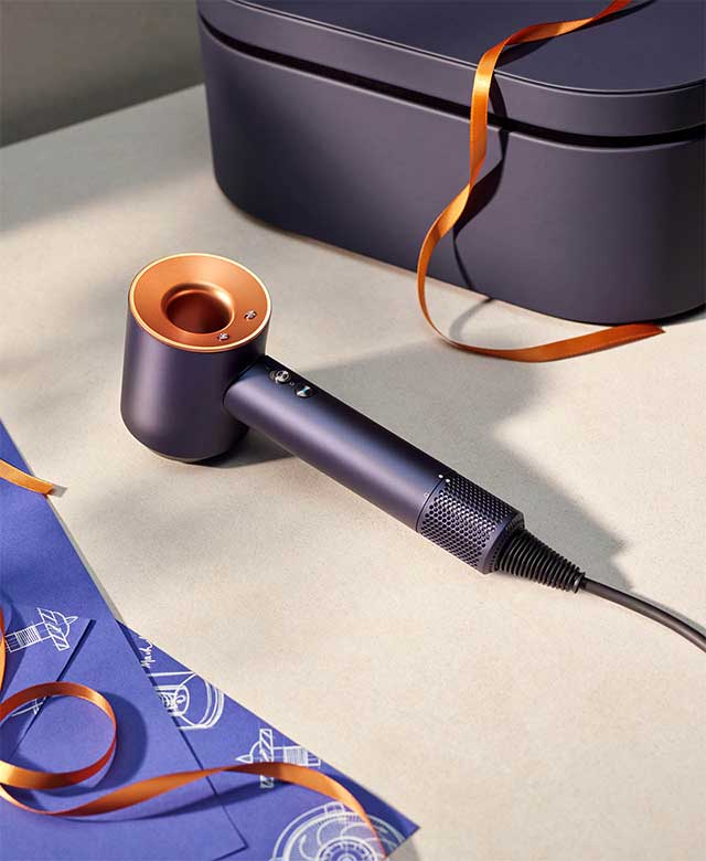 The Dyson Supersonic hair dryer in Prussian blue and rich copper.