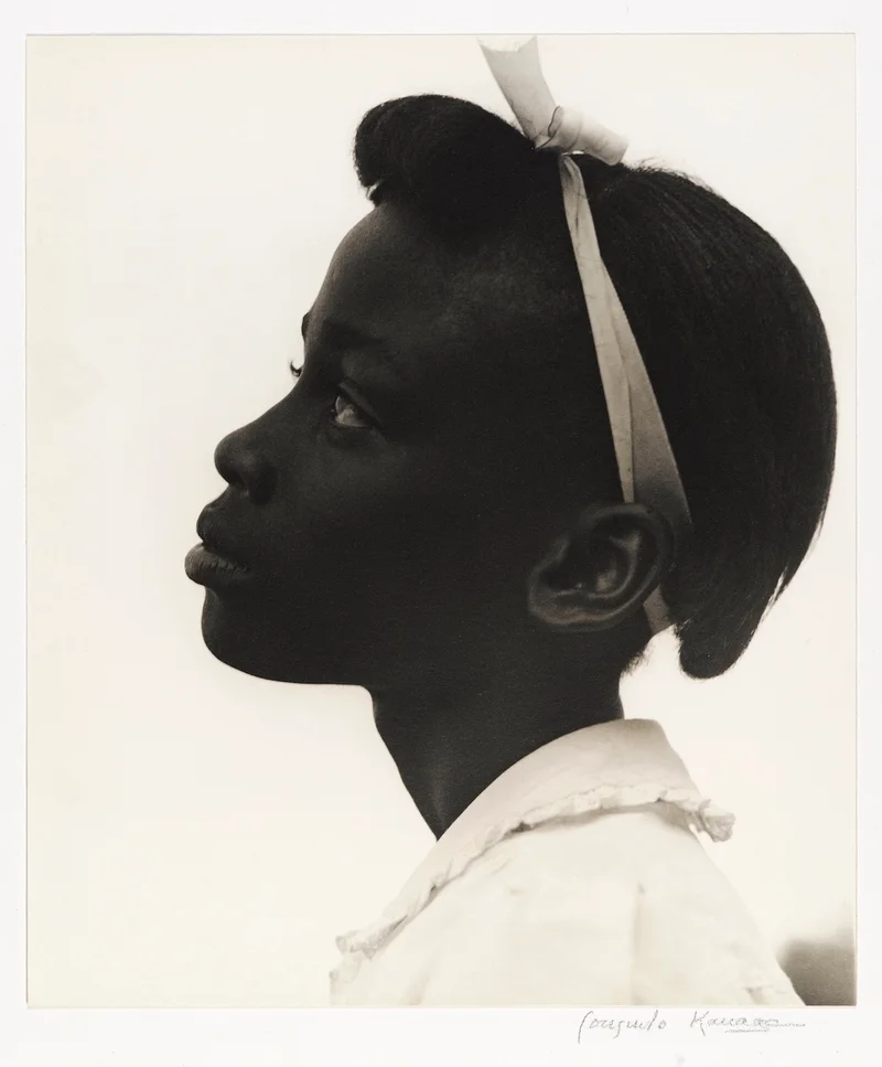 Black-and-white photograph of a child in profile