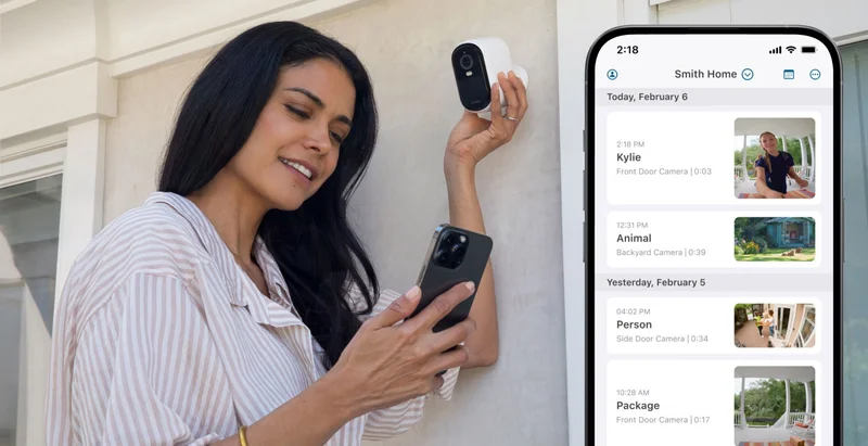Person setting up an Arlo security camera. A phone with a simulated Arlo screen image displays an event feed in the Arlo Secure app.