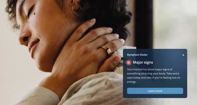 Person holding phone wearing Oura Ring