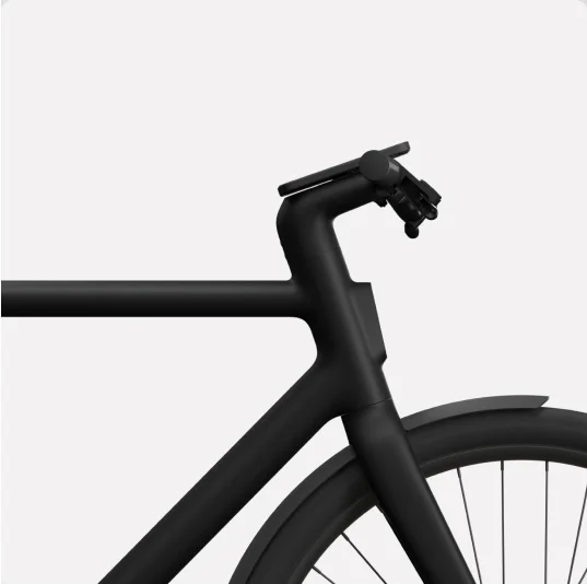 Close-up side view of the front frame, handlebars, and wheel of a Cowboy bike in a black colour, showcasing its sleek design.