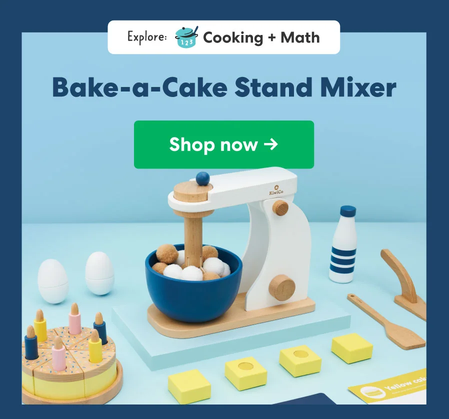 A wooden pretend-play stand mixer surrounded by toy baking ingredients like eggs, butter, and flour on a pastel blue background.