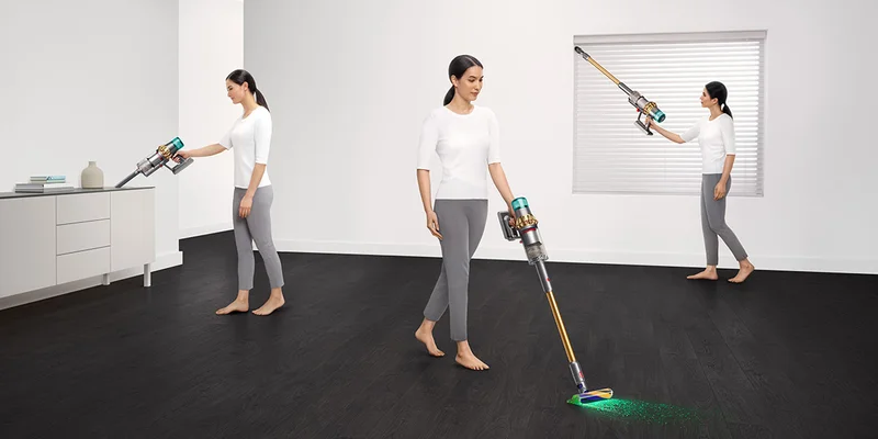Woman cleaning living room with Dyson V15 Detect Absolute vacuum