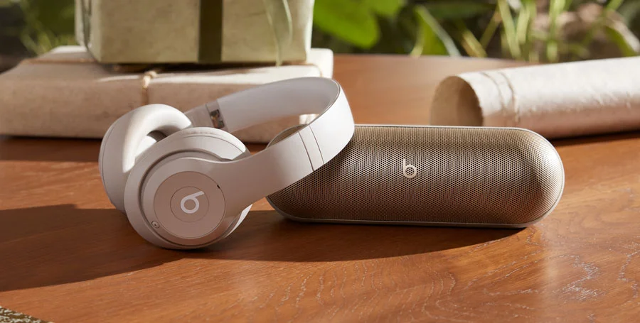 Beats Studio Pro in Sandstone and Beats Pill in Champagne Gold.