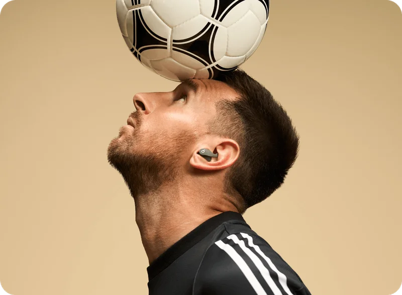 Lionel Messi wearing Beats Fit Pro in Sage Gray.