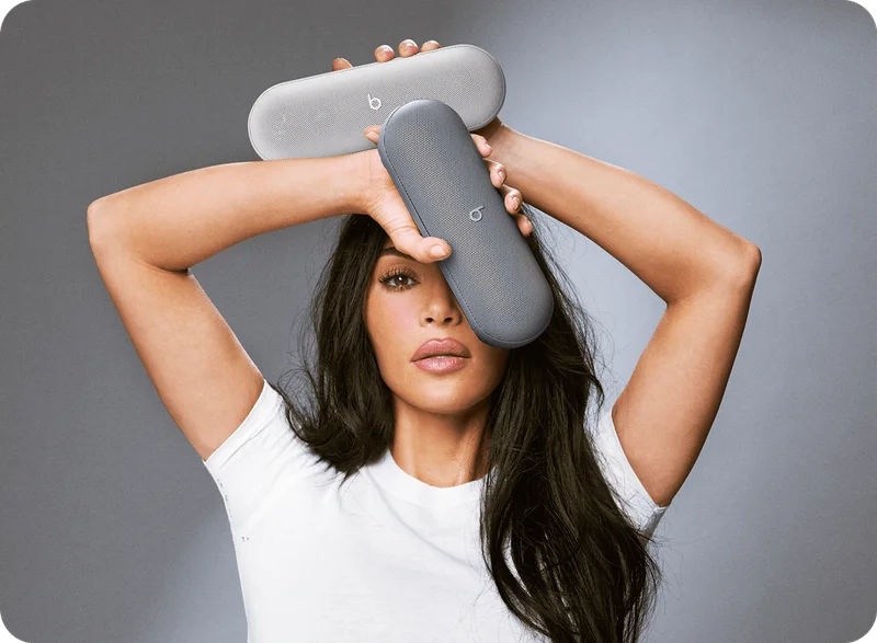 Kim Kardashian holding the Beats Pill in Light Gray and Dark Gray.