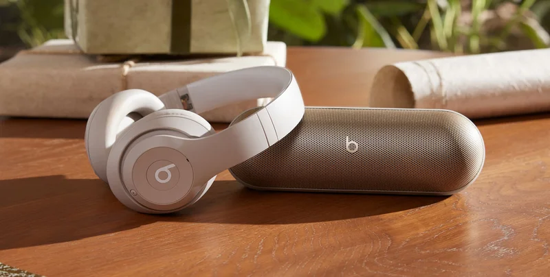 Beats Studio Pro in Sandstone and Beats Pill in Champagne Gold.