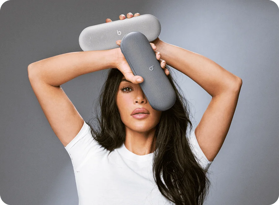 Kim Kardashian holding the Beats Pill in Light Gray and Dark Gray.