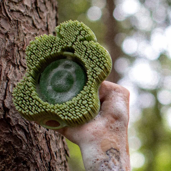 Hand holding a green smoosh with a twin pines bar