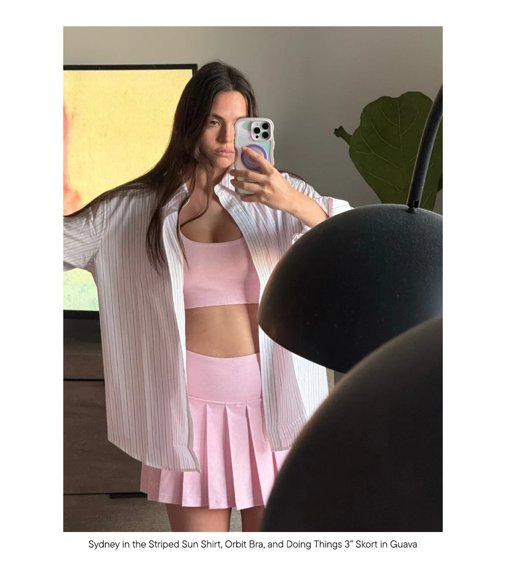 Sydney in the Striped Sun Shirt, Orbit Bra, and Doing Things 3” Skort in Guava