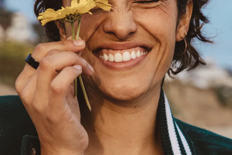 Person wearing Oura Ring holding a flower