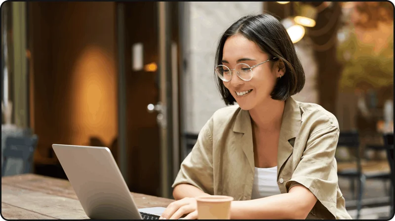 Woman smiling at silver laptop