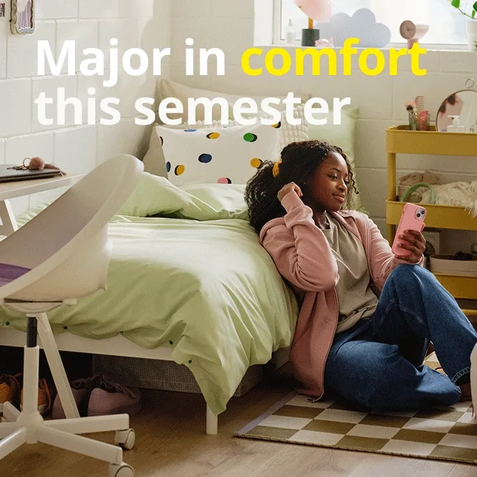 Person sitting next to their bed