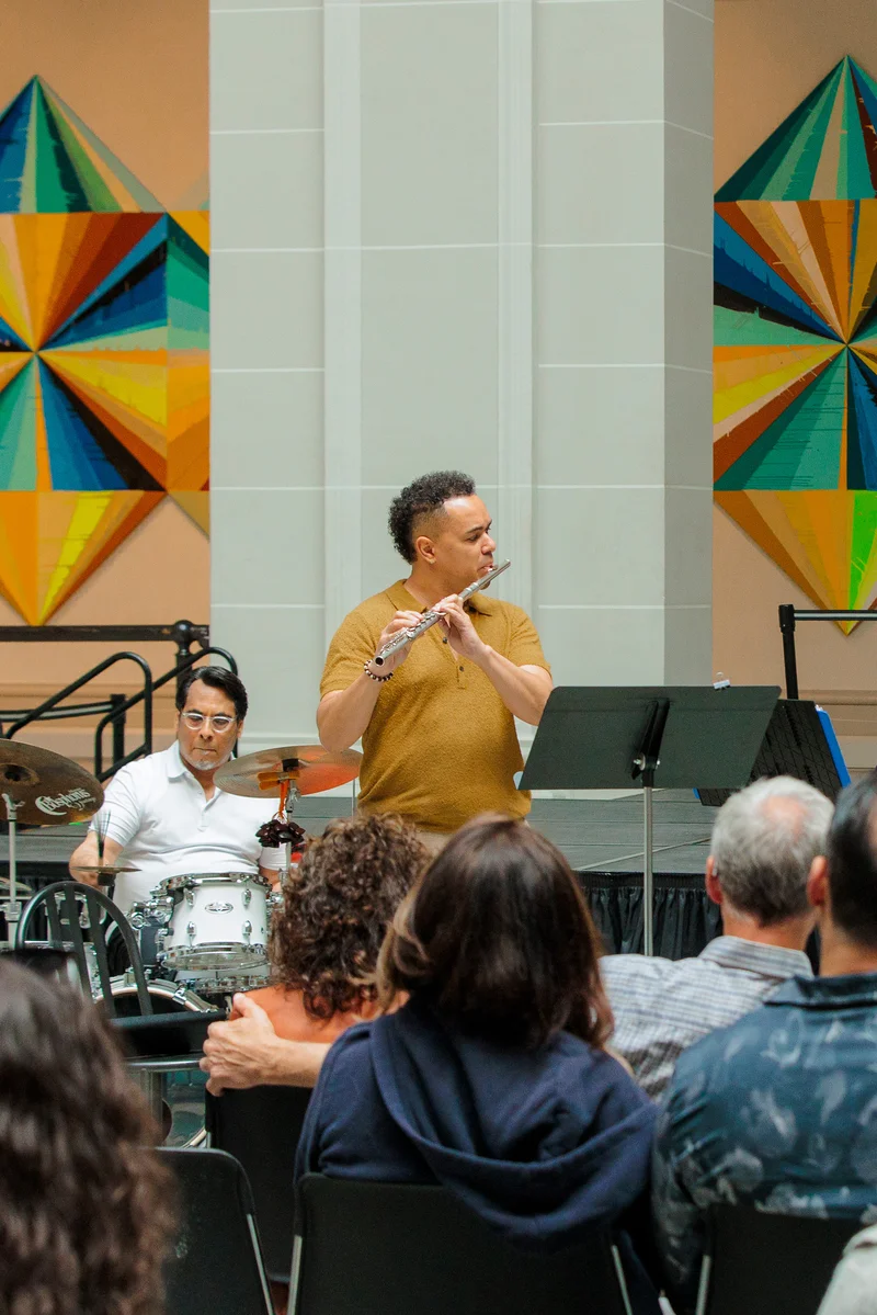 Musicians performing in front of a seated audience
