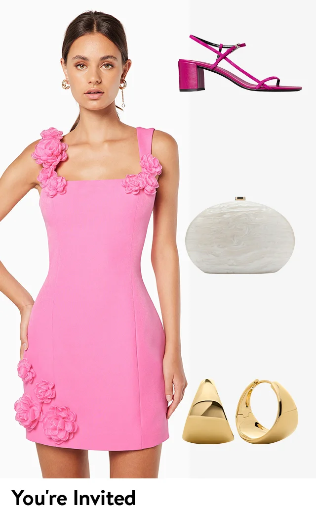 A woman wearing a pink rosette-embellished minidress; a pink ankle strap sandal, oval clutch and gold hoop earrings.