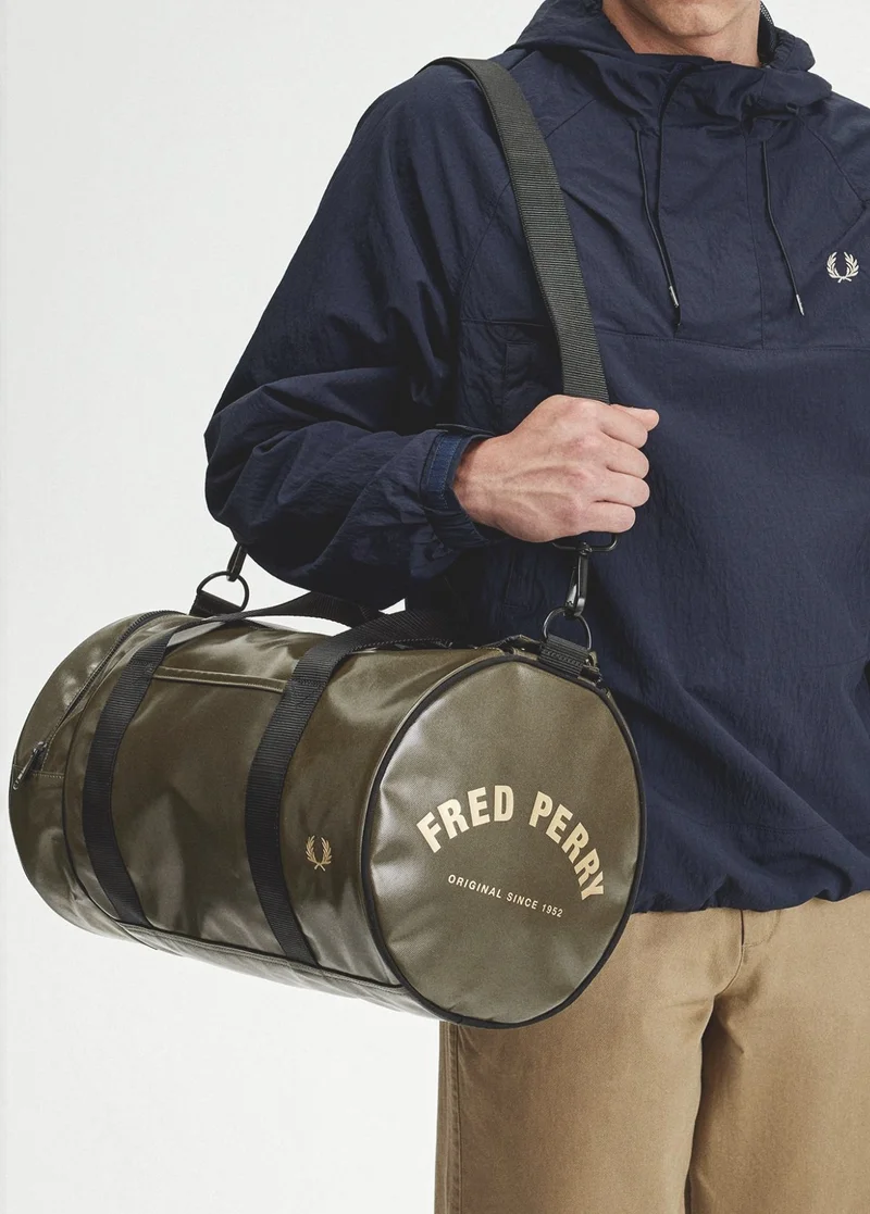 Accessories: Man carries Olive Green Barrel Bag