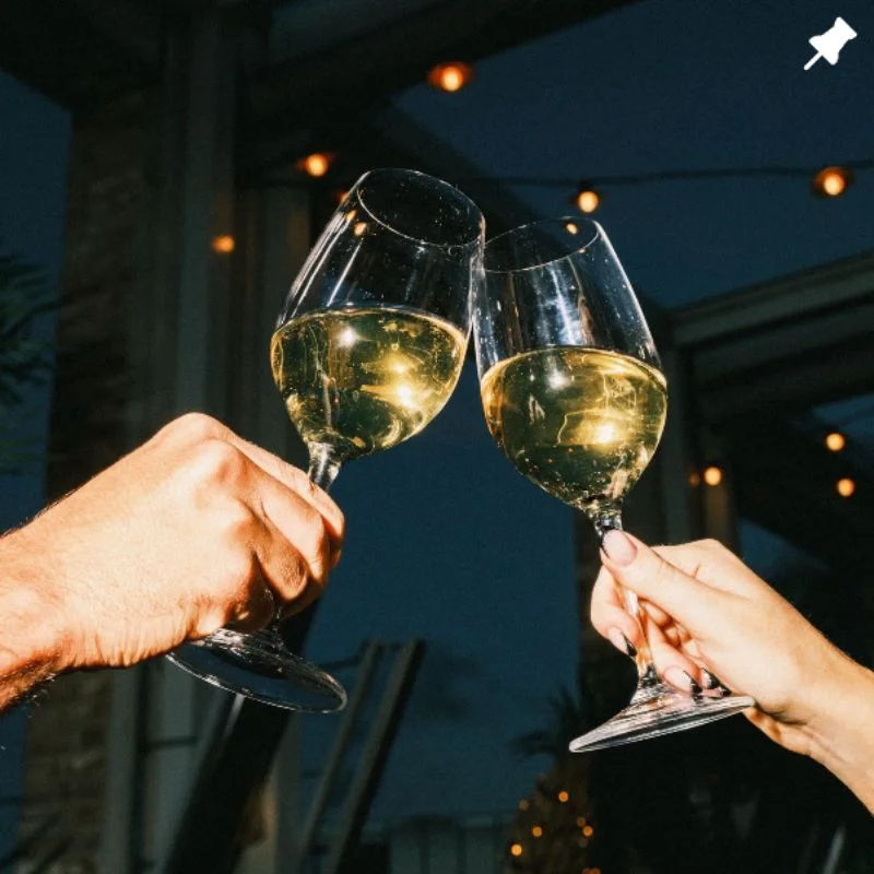 People holding their glasses together for a toast
