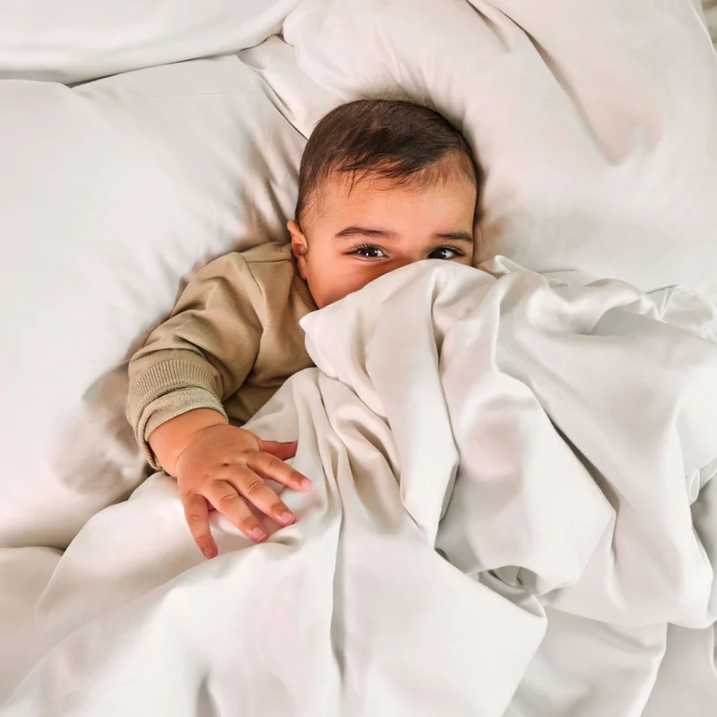 Baby peeking from duvet