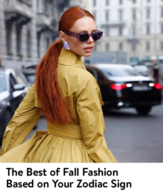 Street-style image of a woman with red hair wearing a yellow trench coat and sunglasses.