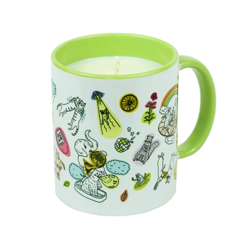 A mug with illustrations on it and a candle inside