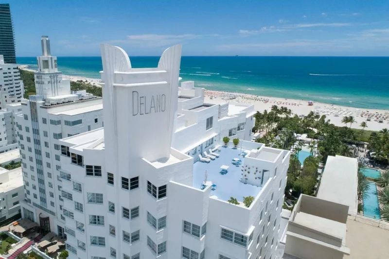 An Art Deco style hotel with a roof lounge and beach view.